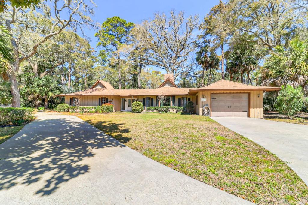 a house with a driveway in front of it at 1 Block to Ocean Fun in Hilton Head Island
