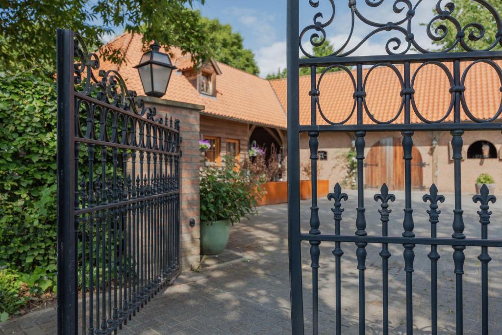 a black wrought iron gate in front of a house at Sams Cottage in Roermond