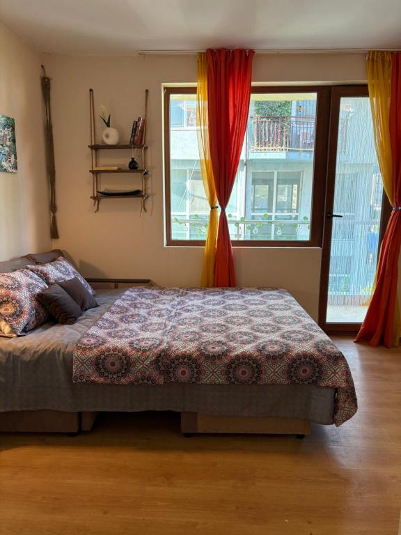 a bedroom with a bed and two windows at Cozy studio in Sunny beach in Sunny Beach