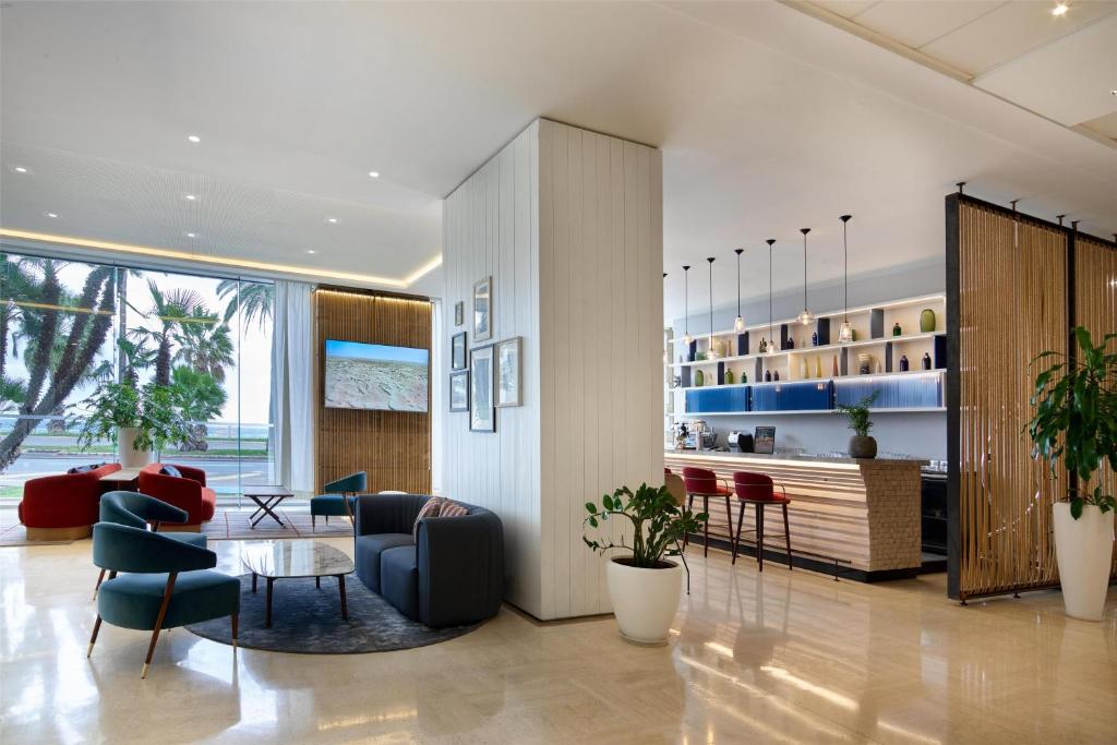 una sala de estar con una mesa y sillas en Radisson Blu Hotel Nice, en Niza