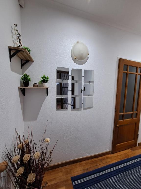 a room with a white wall with some plants on it at Azzure Apartments 6 sleeper Crawford in Cape Town