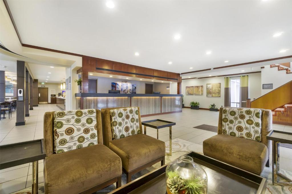 a lobby with two chairs and a table at Best Western Seattle Airport Hotel in SeaTac