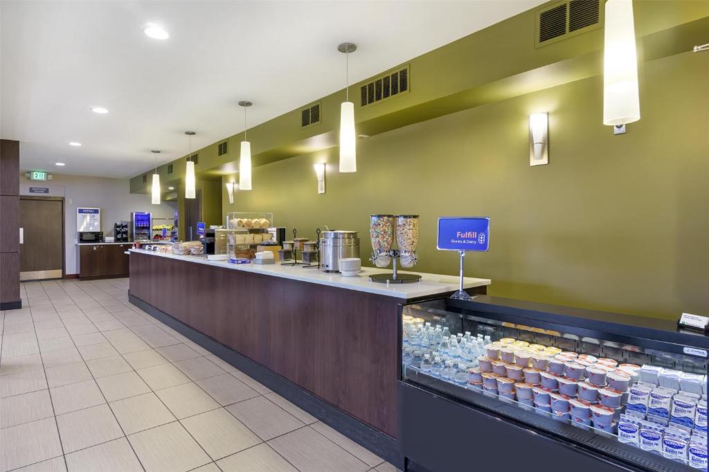 a food court with a counter with bottles of water at Best Western Seattle Airport Hotel in SeaTac