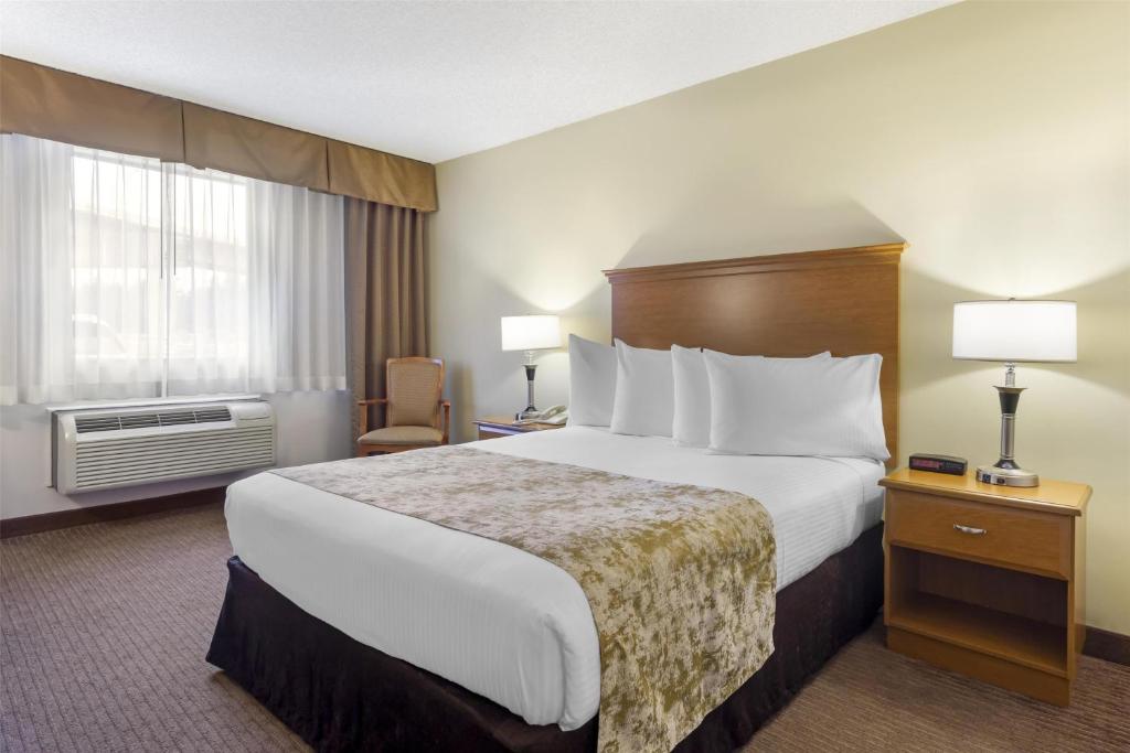 a hotel room with a large bed and a window at Best Western Seattle Airport Hotel in SeaTac