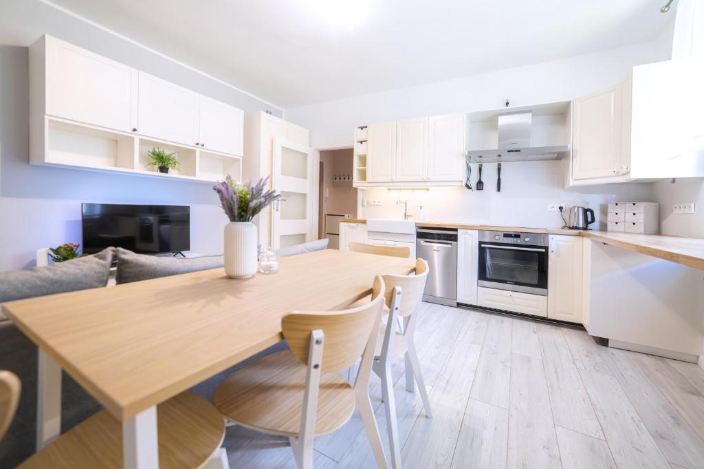 a kitchen and living room with a wooden table and chairs at Baltic Cliff Apartment- Babie Doły in Gdynia