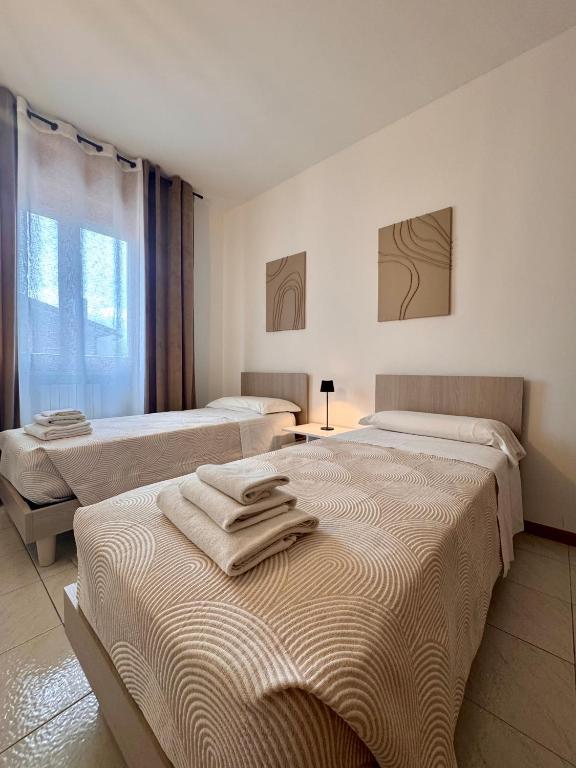 Postel nebo postele na pokoji v ubytování Garda Lake Holiday Apartments quadrilocale