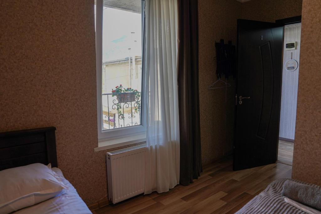 Postel nebo postele na pokoji v ubytování Hotel Elia Kazbegi