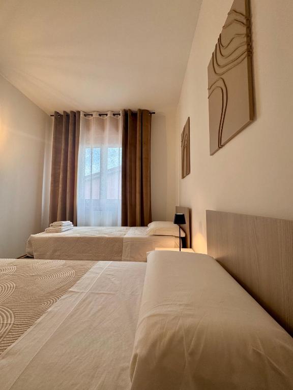 Postel nebo postele na pokoji v ubytování Garda Lake Holiday Apartments quadrilocale