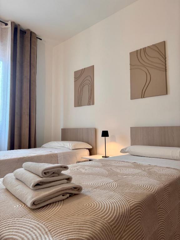 Postel nebo postele na pokoji v ubytování Garda Lake Holiday Apartments quadrilocale