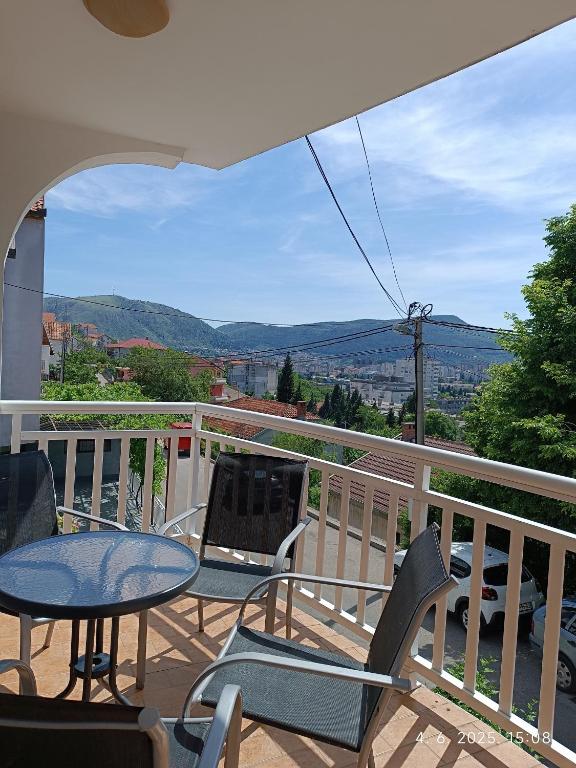 a balcony with chairs and a table and a view at Apartman ASI in Mostar