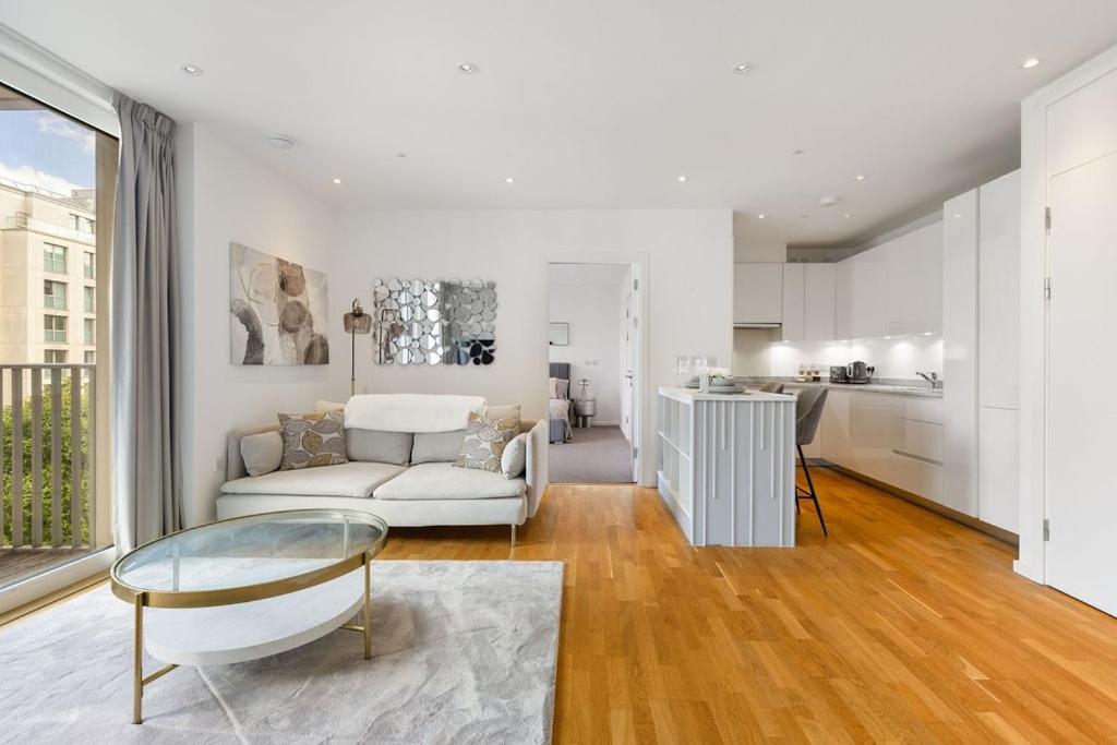 a living room with a couch and a table at Luxury 2 Bed Apt in Olympic Village in London