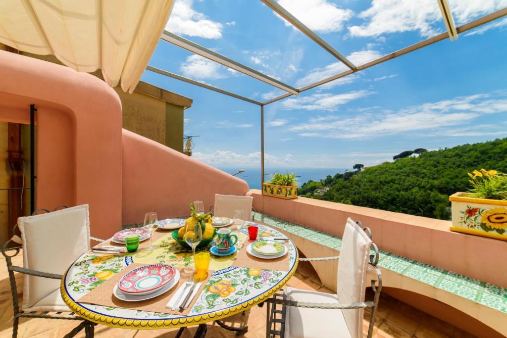 a table and chairs on the balcony of a house at Casa di Zia Rosaria SEA VIEW in Vietri sul Mare