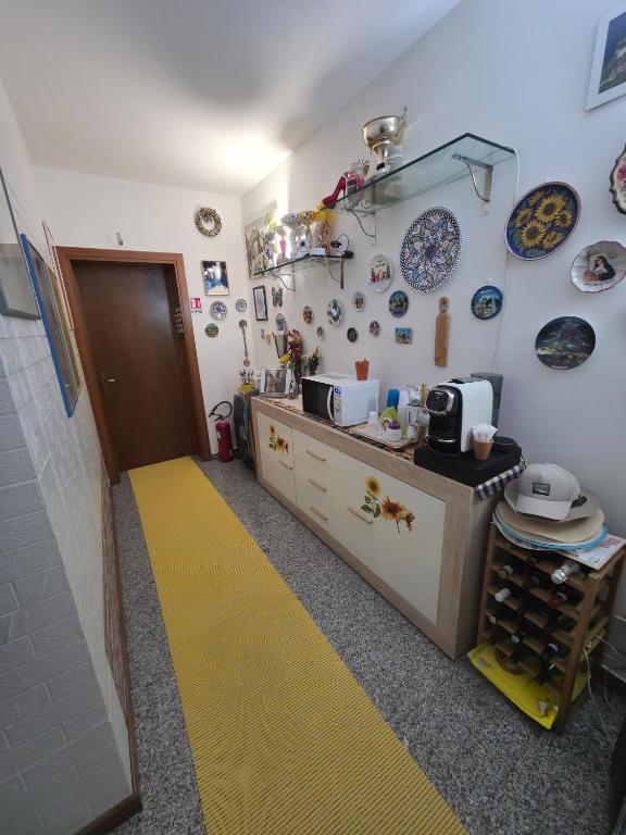 a kitchen with a yellow floor in a room at Affittacamere Girasole in Foligno