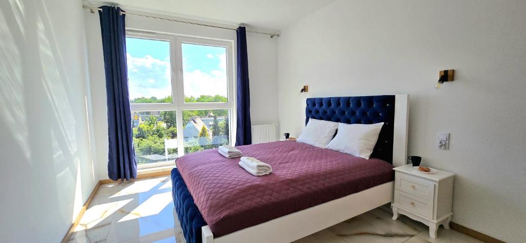 Postel nebo postele na pokoji v ubytování Apartament Brzeźno Breeze by TriApart