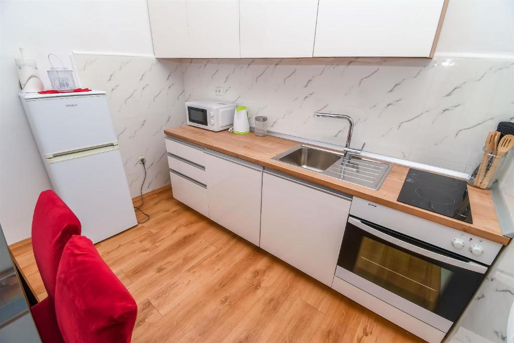 Kuchyň nebo kuchyňský kout v ubytování Apartment Olga