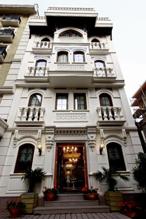 a white building with flowers in front of it at Hotel Niles Istanbul in Istanbul