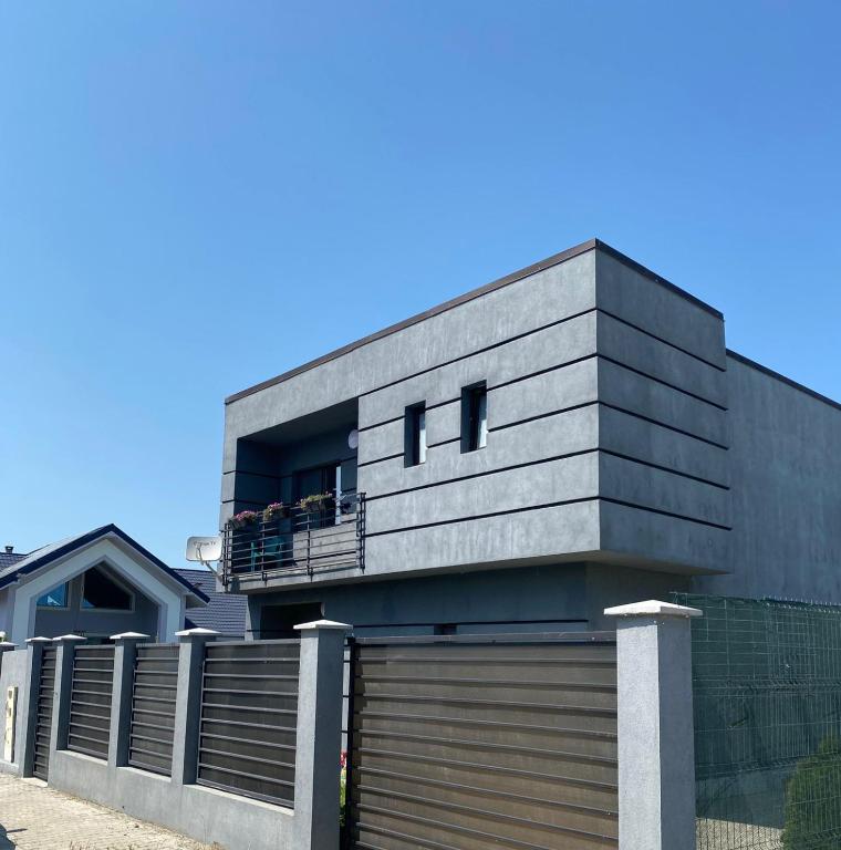 a house with people sitting on a balcony at Vila Antonia in Năvodari