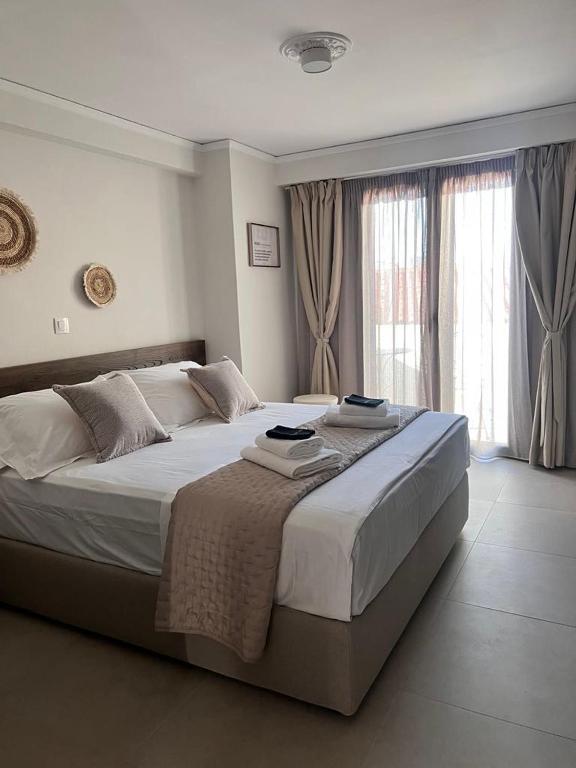 a bedroom with a large bed with two towels on it at Agali Studios in Mytilene