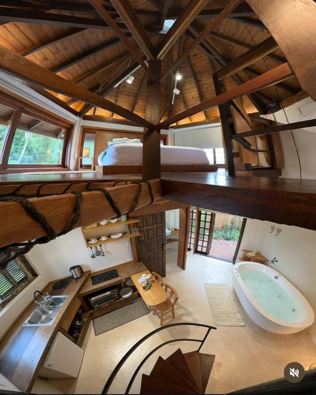an overhead view of a bathroom with a bed and a tub at Refúgio perto do mar em Mariscal - Baoba Suites in Bombinhas