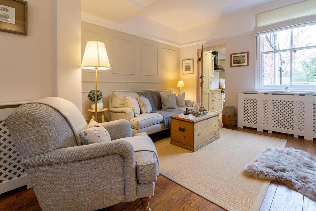 a living room with a couch and a table at The Railway Cottage in Rothley