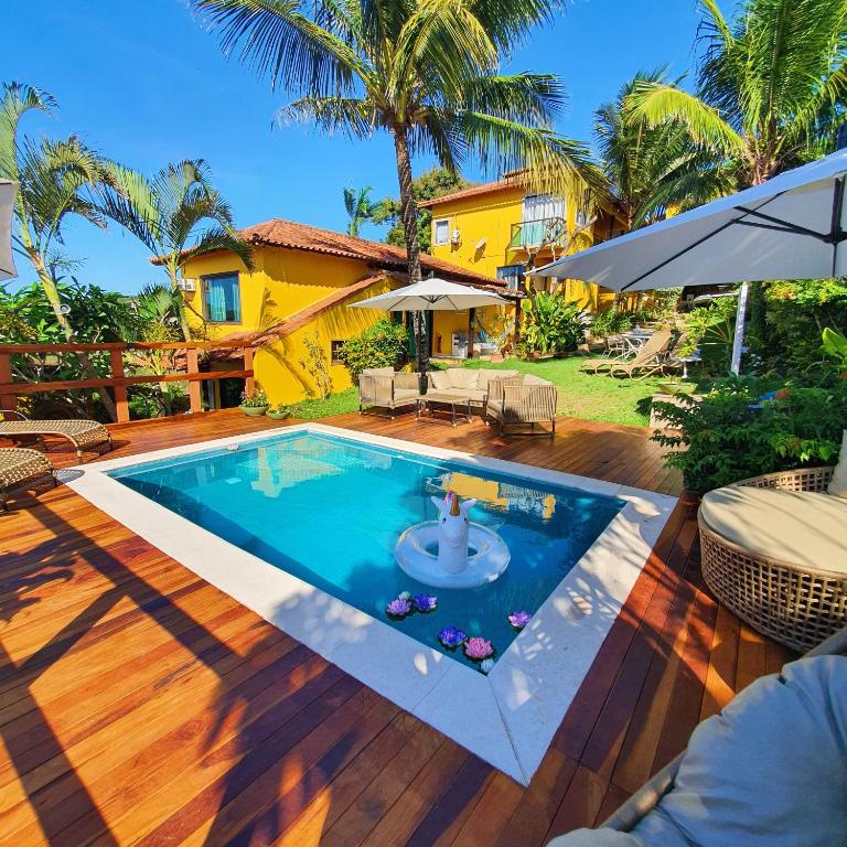 a swimming pool in the backyard of a house at Star Búzios Pousada in Búzios