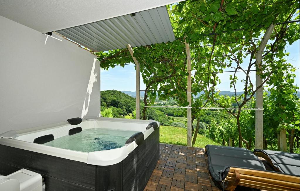 a hot tub on a patio with a view at 1 Bedroom Cozy Home In Remetinec in Remetinec