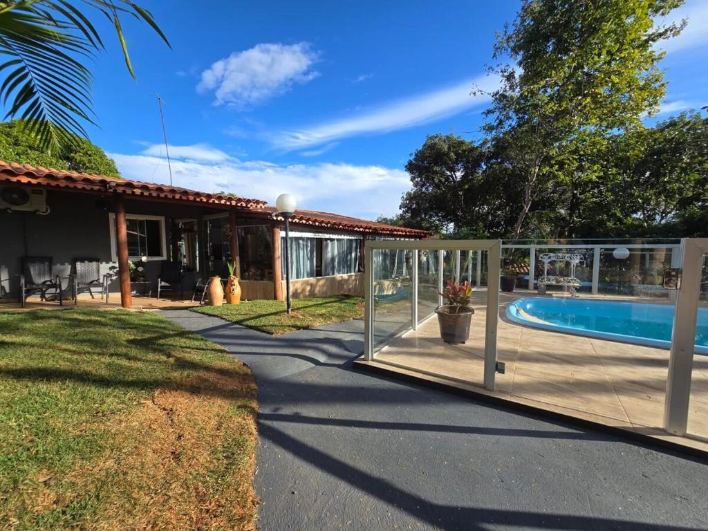 a house with a swimming pool in a yard at Quinta das Palmeiras Area 2 in Montes Claros
