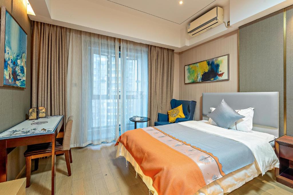 Ένα ή περισσότερα κρεβάτια σε δωμάτιο στο Kaifeisi International Hotel Apartment