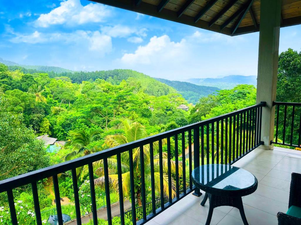 a balcony with a table and a view of the mountains at Grand Hills kandy in Kandy