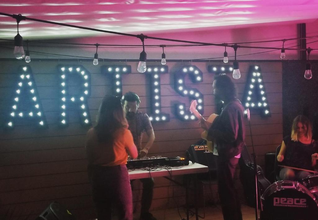 a group of people standing around a table in a room at Wanderlust District in Mexico City