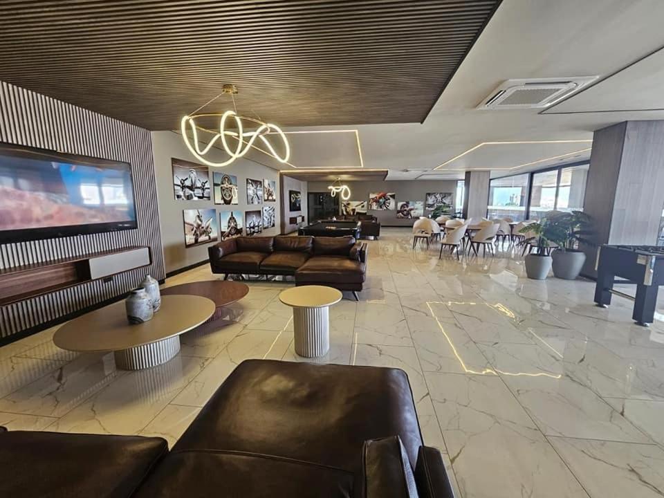 a large living room with couches and a tv at Dpto Home Office - Smart - Piscina - Cowork - Gym in Santa Cruz de la Sierra