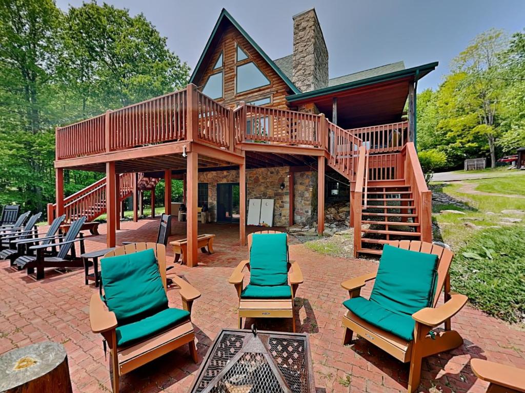 a house with a deck and chairs on a patio at Altitude Adjustment in McHenry