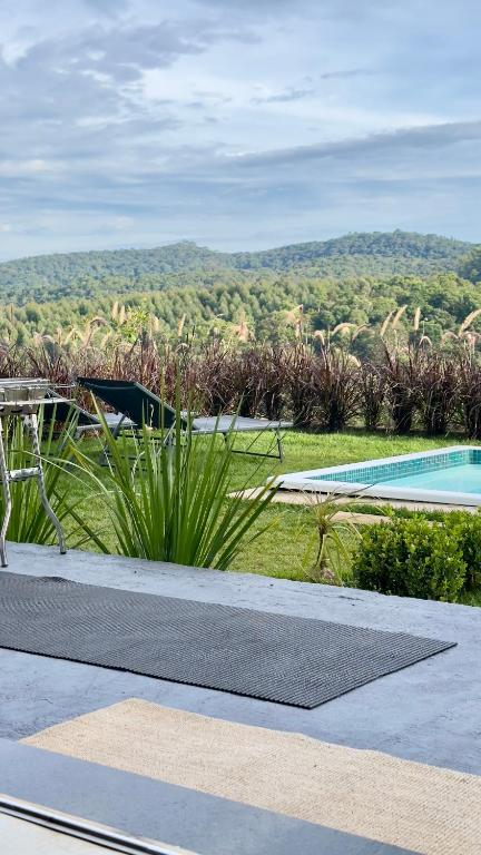 a resort with a pool and a view of the mountains at Villagio vilas boas Monte Verde in Camanducaia