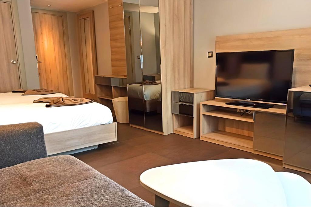 A television and/or entertainment centre at BC Residence Pangaldi