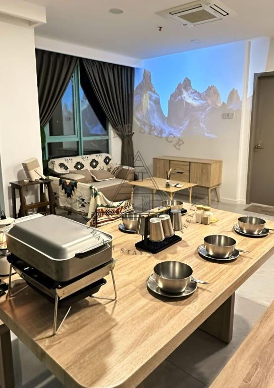 a kitchen with a table with pots and pans on it at AFFT Home Camp - Kota Kinabalu Seaview in Kota Kinabalu