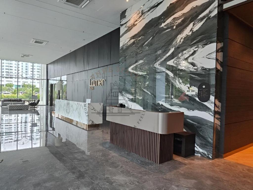 a lobby with a large painting on the wall at AFFT Home Camp - Kota Kinabalu Seaview in Kota Kinabalu