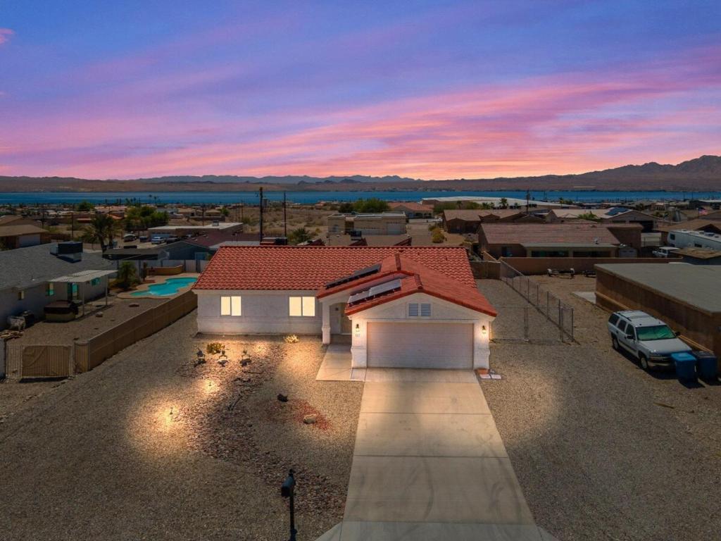 a small white house with a red roof at Lake View, Themed Rooms, King Beds, Fire Pit in Lake Havasu City