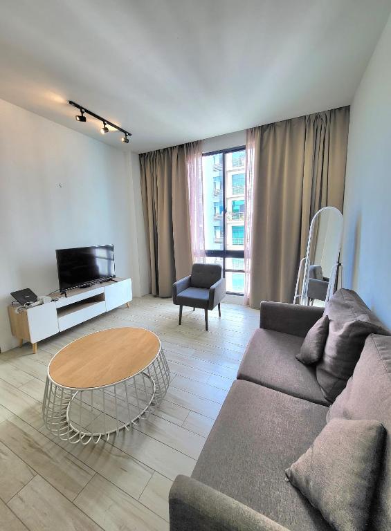 a living room with a couch and a table at Zen66 @ Roxy Serviced Apartment in Kuching
