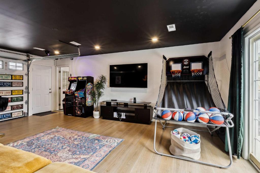 a living room with a bowling alley with a game at Charming 3-Bedroom - Hot Tub & Game Room in Vermilion