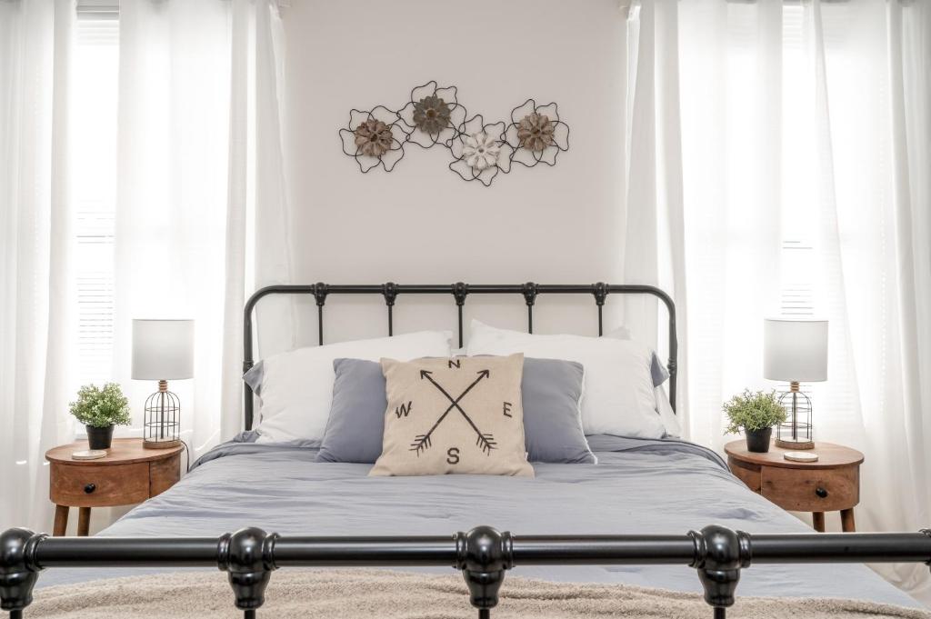 a bedroom with a bed with a clock on it at Historic Ludlow Apt B in Ludlow