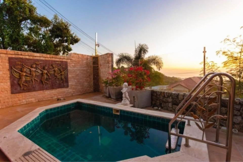 a swimming pool in front of a house at Karon Sunset Seaview Villa by 789property in Karon Beach