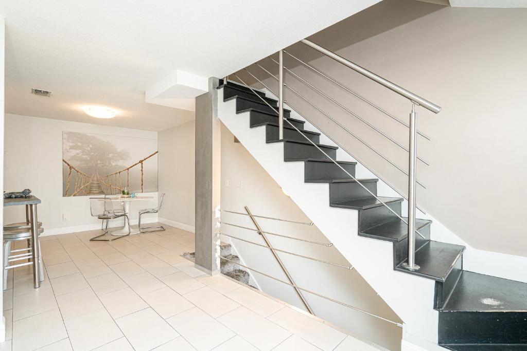 a metal staircase in a living room with a table at Long Island at Laguna Point in Destin