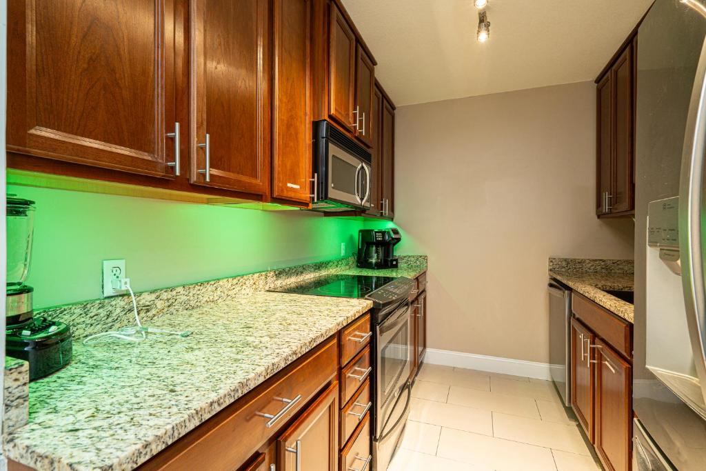 a kitchen with wooden cabinets and granite counter tops at Long Island at Laguna Point in Destin