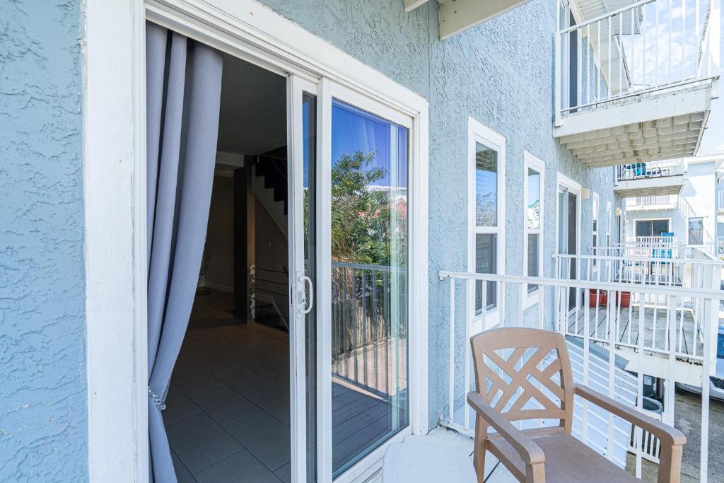 a balcony with a wooden chair on a house at Long Island at Laguna Point in Destin