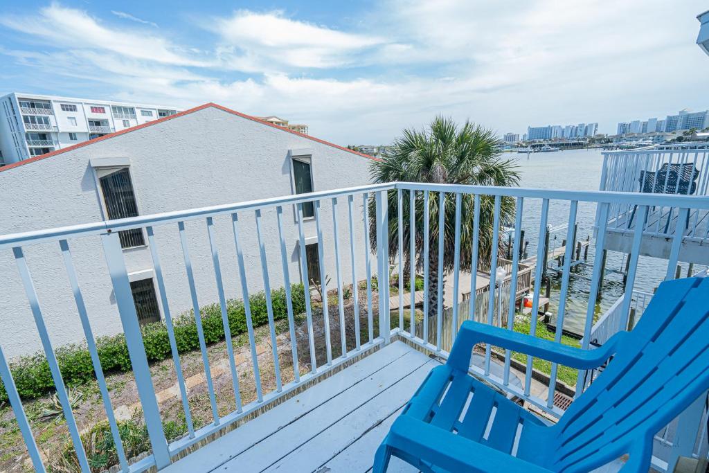 a balcony with two blue chairs and the water at Long Island at Laguna Point in Destin