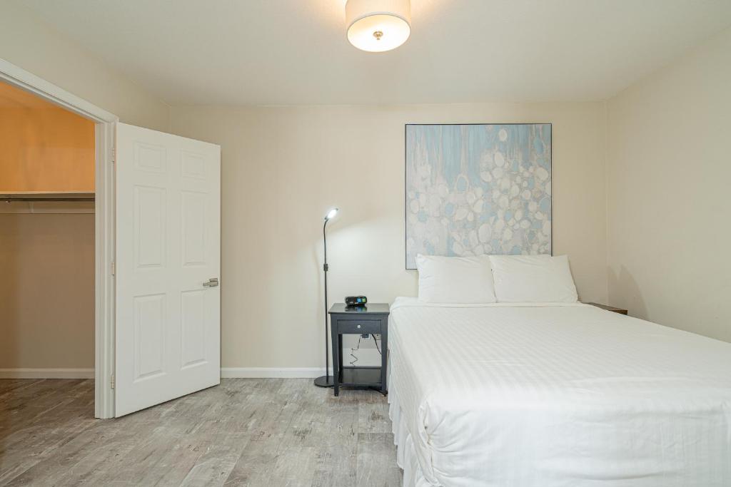 a bedroom with a white bed and a painting on the wall at Long Island at Laguna Point in Destin