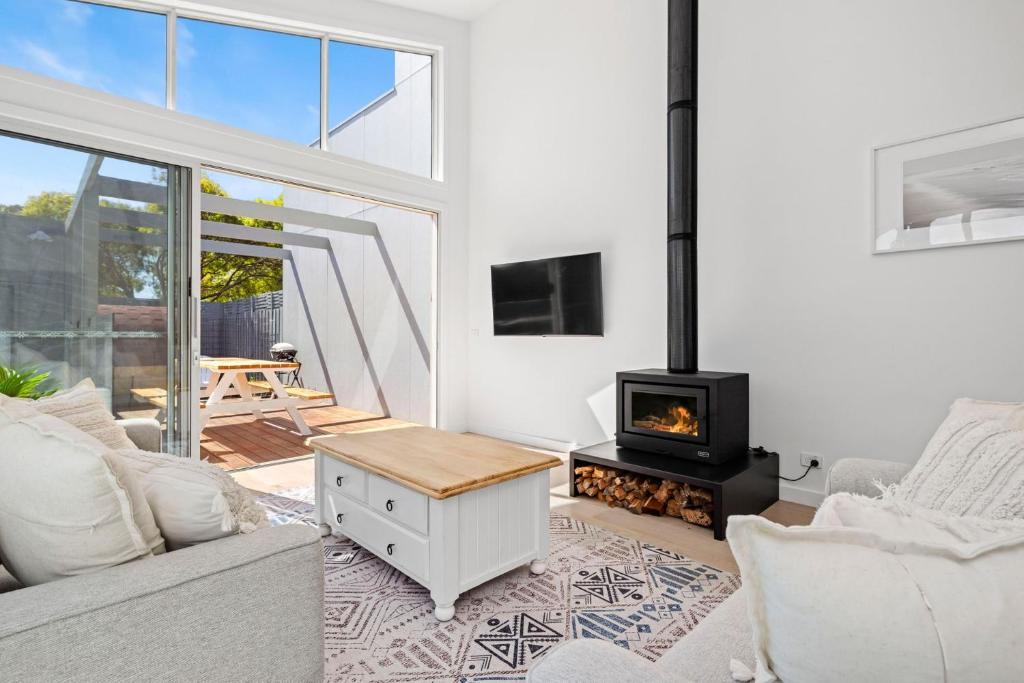 a living room with a couch and a stove at The Sanctuary in Rosebud