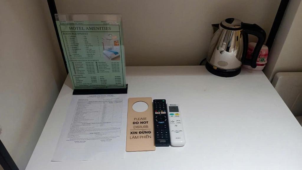 a table with a remote control and a box on it at Lexington Hotel in Ho Chi Minh City