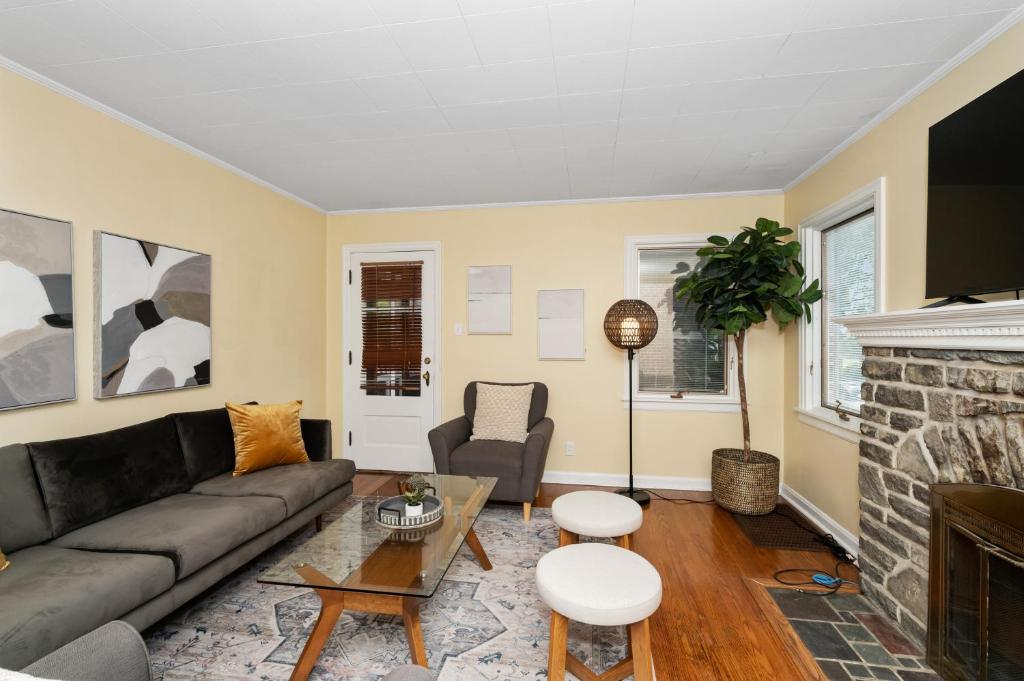 a living room with a couch and a fireplace at The Cincinnati Charm in Cincinnati