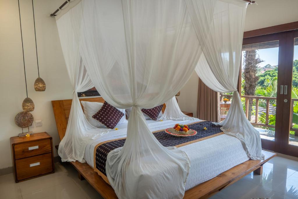 Postel nebo postele na pokoji v ubytování Mahadana Ubud